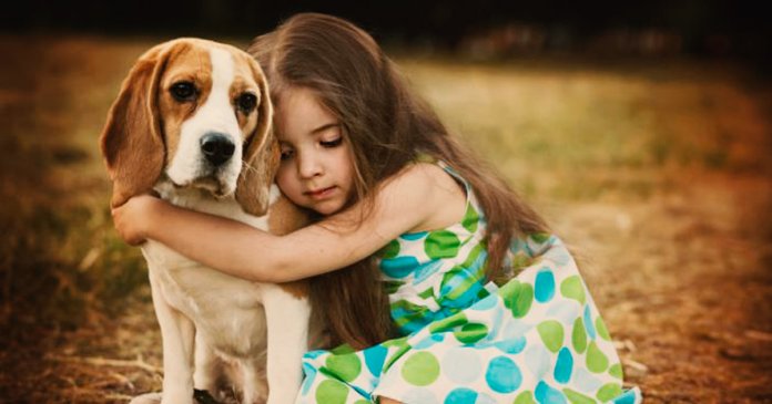 Child-hugging-dog-750x458