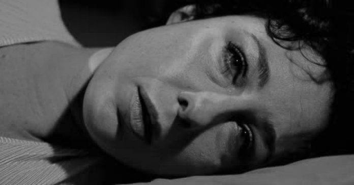 Sad Desperate Woman Crying on bed in the night- Closeup